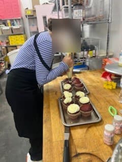 Piping cupcake frosting at Antonio's Macarons camp