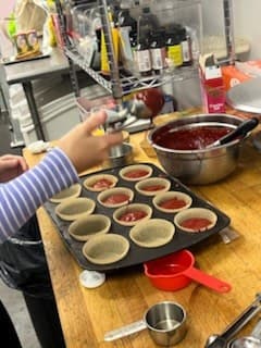 Prepping the muffin tin at Antonio's Macarons camp