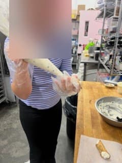 Filling cannoli shells at Antonio's Macarons camp