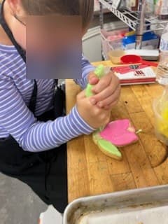 Decorating flower cookies at Antonio's Macarons camp